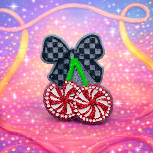 Decorative freshie with a checkered bow and cherry pepperminut design on a colorful, wavy background.