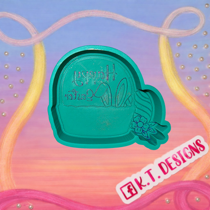 Green freshie mould with easter bucket on a colorful background with 'K.T. Designs' branding.